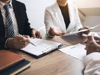 Couple reviewing documents with divorce lawyer